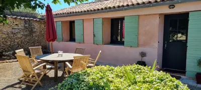 a table and chairs in front of a house at La BERGERIE in Pélissanne
