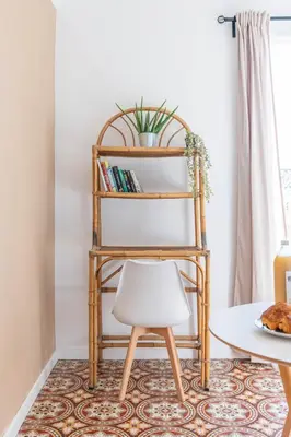 a chair in a living room with a book shelf at Appartement spacieux, chaleureux & tout confort in Pertuis
