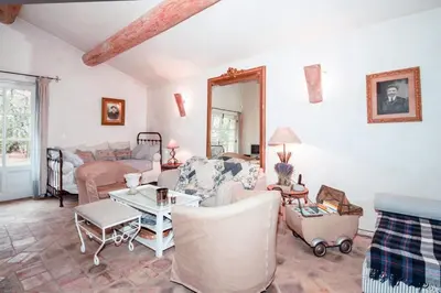 a living room with a couch and a table at Authentique Bergerie Coeur Luberon in Lacoste
