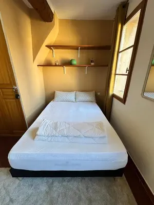 a small bedroom with a bed in a small room at Aix Centre Rue d'Italie - T2 40m2 Rénové - à 2 pas du Cours Mirabeau in Aix-en-Provence