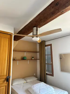 a bedroom with a ceiling fan and a bed at Aix Centre Rue d'Italie - T2 40m2 Rénové - à 2 pas du Cours Mirabeau in Aix-en-Provence