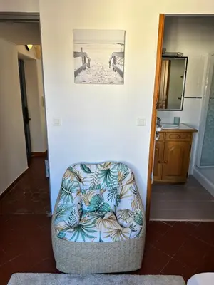 a chair in a room with a picture on the wall at Aix Centre Rue d'Italie - T2 40m2 Rénové - à 2 pas du Cours Mirabeau in Aix-en-Provence