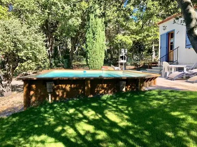 a ping pong table in the middle of a yard at Gite PROVENCE MONT VENTOUX in Malemort-du-Comtat