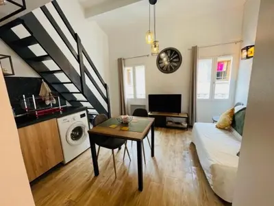 a living room with a couch and a table at City break in old center Aix! in Aix-en-Provence
