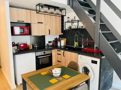 a kitchen with a table and a washer in a kitchen at City break in old center Aix! in Aix-en-Provence