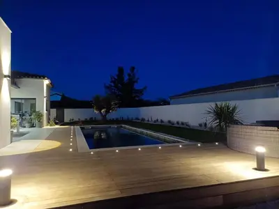 a house with a swimming pool at night at Villa moderne au coeur de la provence in Pernes-les-Fontaines