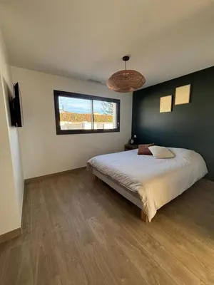 a bedroom with a large bed and a window at Villa moderne au coeur de la provence in Pernes-les-Fontaines