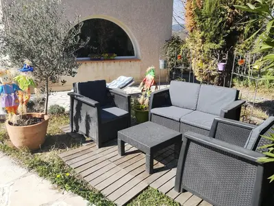 a patio with chairs and a couch and a table at Chambre d'hôte à Pierrevert, en Haute Provence in Pierrevert