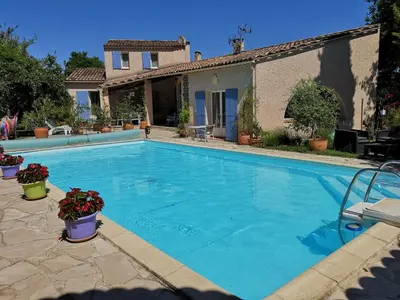 a large swimming pool in front of a house at Chambre d'hôte à Pierrevert, en Haute Provence in Pierrevert