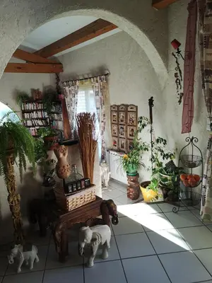a room with a table with dogs on the floor at Chambre d'hôte à Pierrevert, en Haute Provence in Pierrevert