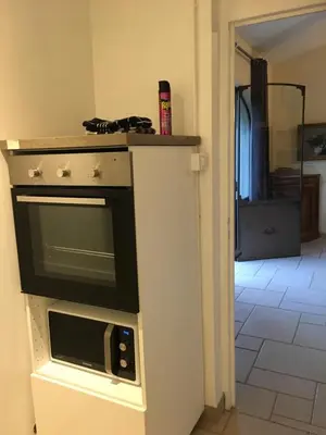 a kitchen with a microwave on a counter at Le Bois De La Cour in Roussillon