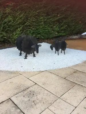two figurines of cows standing on the ground at Le Bois De La Cour in Roussillon
