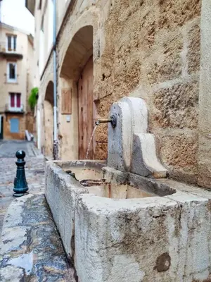 a water fountain on the side of a building at New! Le zola studio lumineux en centre ville in Aix-en-Provence