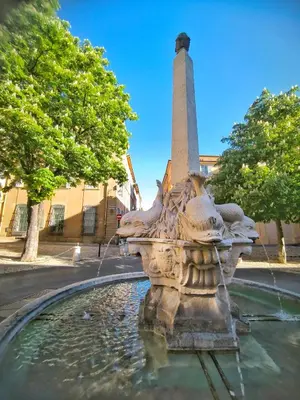 a fountain with a monument in the background at New! Le zola studio lumineux en centre ville in Aix-en-Provence