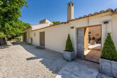 a house with a garage and two trees in front of it at Villa Kiki 4 chambres Climatisée Ménerbes in Ménerbes