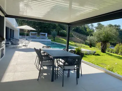 a patio with a table and chairs and a pool at Villa Moderne 5 chambres - Aix-En-Provence - piscine in Le Tholonet