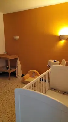 a room with a staircase and a yellow wall at Escale vélo La petite Reine in Cavaillon