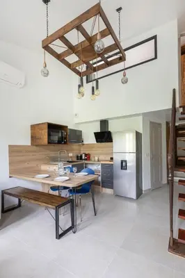 a kitchen with a wooden table and blue chairs at Le Duplex des Ocres - 2 bedrooms - Air conditioning - WiFi in Apt