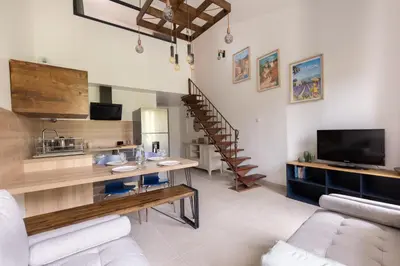 a living room with a couch and a table at Le Duplex des Ocres - 2 bedrooms - Air conditioning - WiFi in Apt