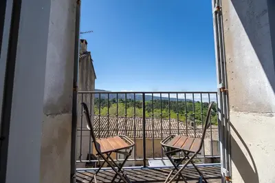 two chairs sitting on a balcony with a view at Chez Marthe - Maison de village - Ménerbes centre in Ménerbes