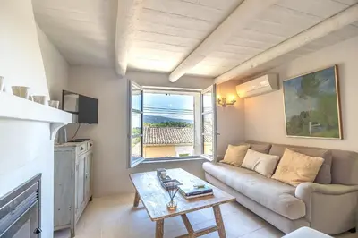 a living room with a couch and a table at Chez Marthe - Maison de village - Ménerbes centre in Ménerbes
