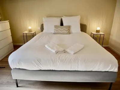 a large white bed with two towels on it at Les Calanques - Mas des Sous-Bois in Ventabren