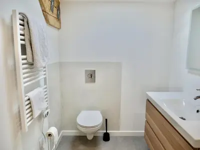 a white bathroom with a toilet and a sink at Les Calanques - Mas des Sous-Bois in Ventabren