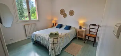 a bedroom with a bed with a bag on it at Villa Rosa peaceful haven 10m from Aix 11 guests in Aix-en-Provence