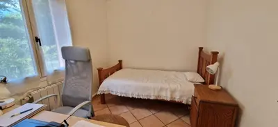 a small bedroom with a bed and a desk and a chair at Villa Rosa peaceful haven 10m from Aix 11 guests in Aix-en-Provence