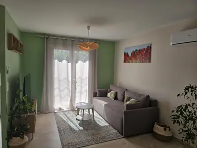 a living room with a couch and a window at Cocoon Luberon in Lauris