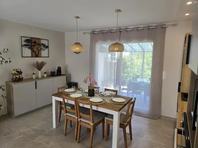 a kitchen and dining room with a table and chairs at Cocoon Luberon in Lauris