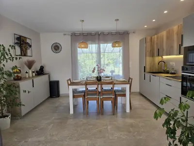 a kitchen with a table and chairs and a window at Cocoon Luberon in Lauris