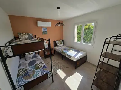 a room with two bunk beds and a window at Cocoon Luberon in Lauris