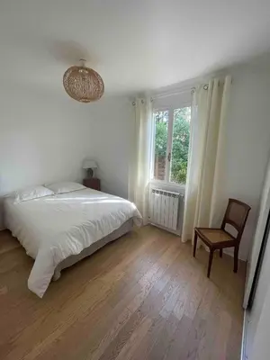a bedroom with a bed and a chair and a window at Provencal villa with pool and large terrace in Rognac