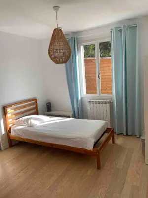 a bedroom with a bed and a window at Provencal villa with pool and large terrace in Rognac
