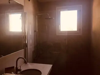a bathroom with a shower and a sink and a window at Provencal villa with pool and large terrace in Rognac