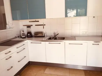 a kitchen with white cabinets and a sink at Provencal villa with pool and large terrace in Rognac
