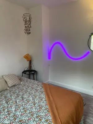 a bedroom with a bed with a purple line on the wall at Joli rez de villa proche d'Aix-en-Provence in Peyrolles-en-Provence