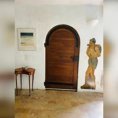 a room with a wooden door and a painting on the wall at Bastide de Bénezet in Mérindol