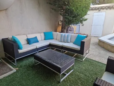 a patio with a couch and a table at Magnifique maison de ville avec piscine au cœur de la Provence in Salon-de-Provence