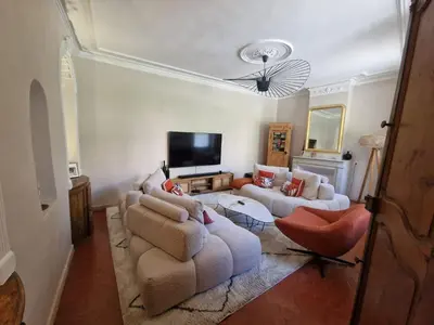 a living room with two couches and a tv at Magnifique maison de ville avec piscine au cœur de la Provence in Salon-de-Provence