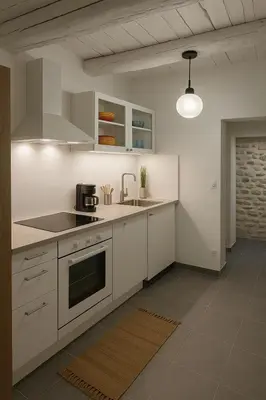 a kitchen with white cabinets and a stove top oven at Maison de Charme Rénovée 3 Chbres Hyper Centre Historique in LʼIsle-sur-la-Sorgue