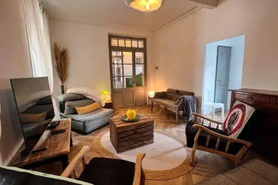 a living room with a couch and a table at Elivi Elegant Art Deco house with Garden Walk to the Heart of Town in LʼIsle-sur-la-Sorgue