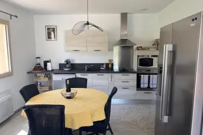 a kitchen with a table and a refrigerator at 