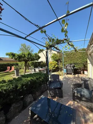 a patio with chairs and a table and a grill at Maison Tamaris in LʼIsle-sur-la-Sorgue