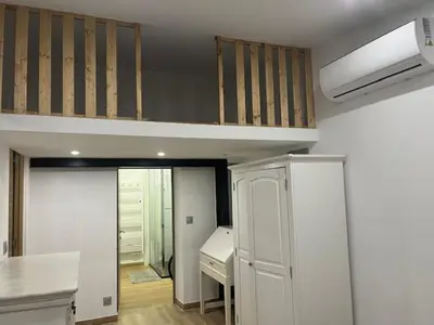 an empty room with a loft bed and a desk at Mas des trois sautets in Meyreuil