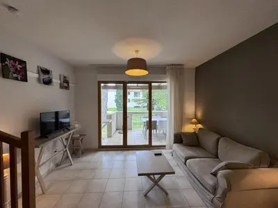 a living room with a couch and a tv at résidence avec piscines à proximité de Gordes in Gordes