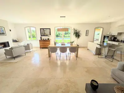 a large living room with a table and chairs at Villa haut de gamme avec piscine et grand jardin in Aix-en-Provence