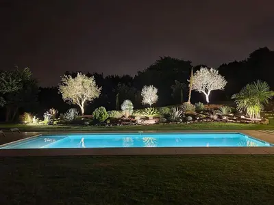 a swimming pool in a yard at night at Villa haut de gamme avec piscine et grand jardin in Aix-en-Provence
