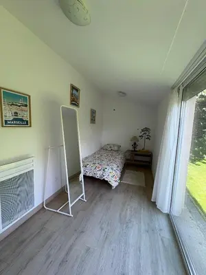 a bedroom with a bed and a mirror in it at Logement avec jardin et terrain de pétanque privé in Venelles